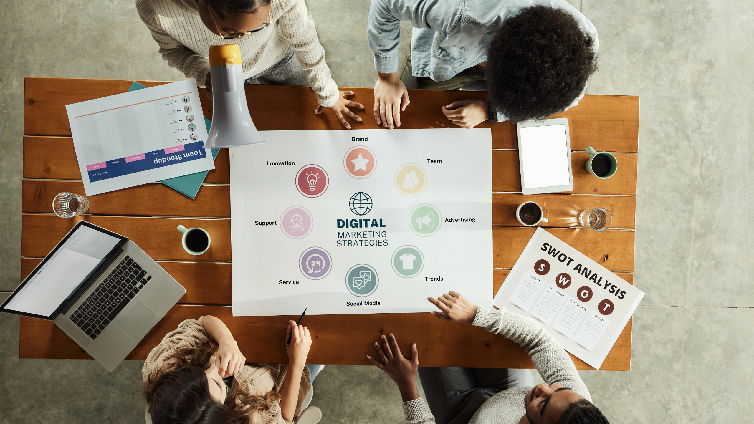 Team collaborating around a digital marketing strategy chart with SEO, content, social media, and analytics
